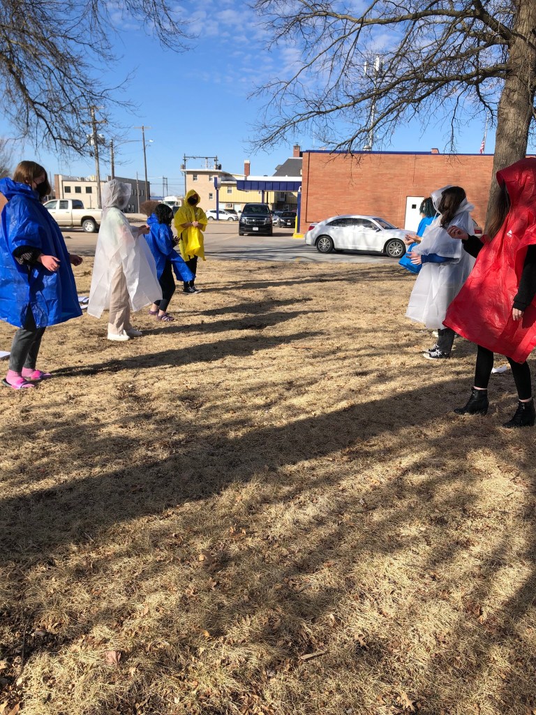 High school physics students participate in an egg toss lab demonstrating the effects of momentum and impact time